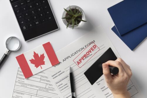 Canadian study visa approval setup featuring passports, a Canadian flag, and an “Approved” stamp, representing Canada Visa Policy 2025 changes for international students.